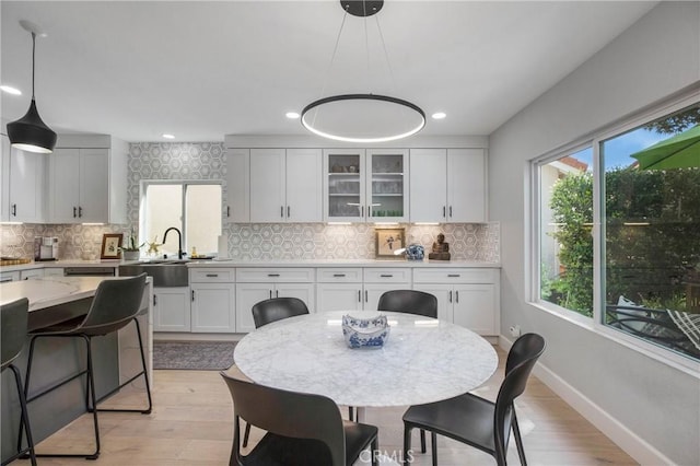 dining space featuring recessed lighting, baseboards, and light wood finished floors