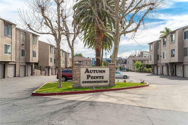 community / neighborhood sign with community garages and a residential view