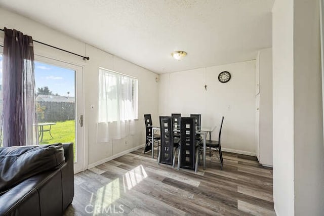 dining area featuring wood finished floors and baseboards