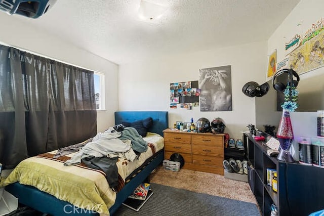 bedroom with a textured ceiling and carpet