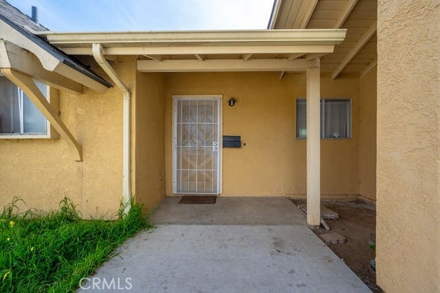 doorway to property with stucco siding