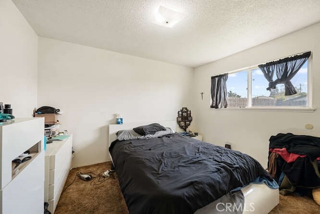 bedroom with carpet flooring and a textured ceiling