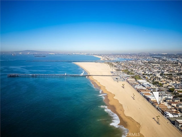 birds eye view of property featuring a beach view and a water view