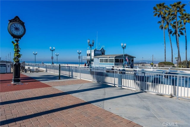 exterior space featuring a water view and street lighting