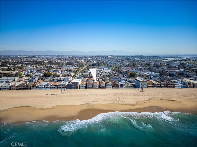 drone / aerial view with a view of the beach and a water and mountain view