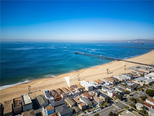 birds eye view of property featuring a view of the beach, a water view, and a residential view