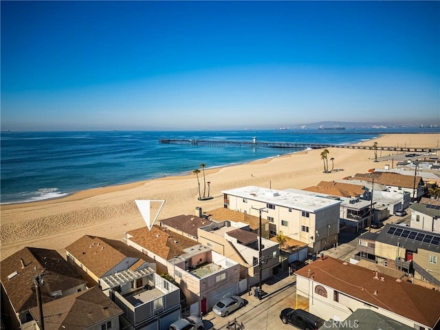 bird's eye view with a water view and a beach view