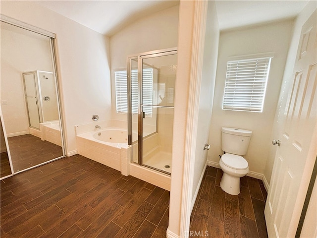 full bath with wood finish floors, a garden tub, a stall shower, and toilet