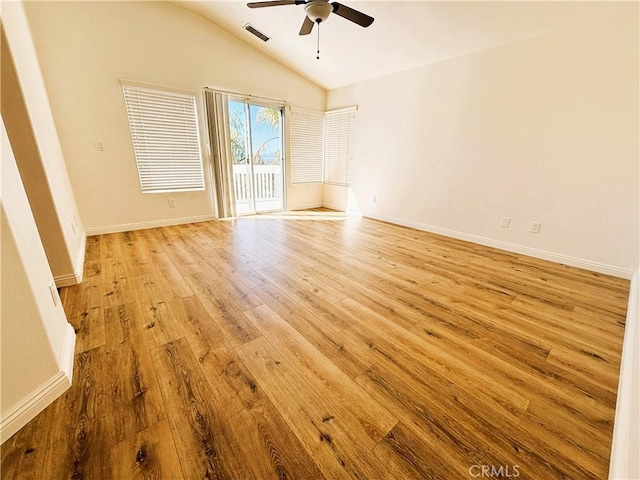 unfurnished room featuring baseboards, visible vents, lofted ceiling, ceiling fan, and light wood-style floors