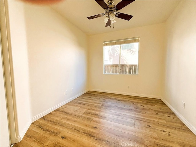 unfurnished room with baseboards, ceiling fan, and light wood finished floors