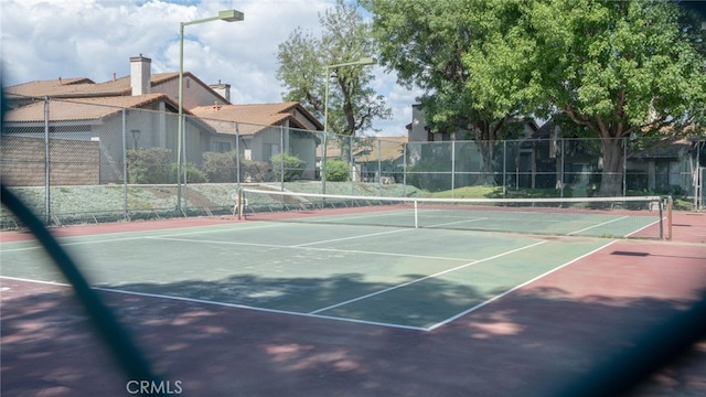 view of sport court with fence