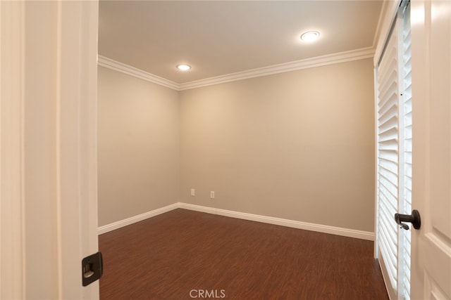 spare room featuring dark wood-style floors, recessed lighting, baseboards, and ornamental molding