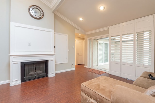 living area with wood finished floors, baseboards, lofted ceiling, a fireplace, and crown molding