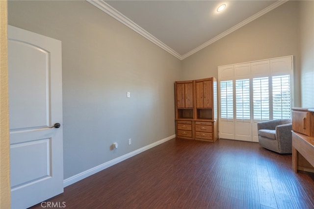 interior space featuring dark wood-style floors, ornamental molding, baseboards, and vaulted ceiling