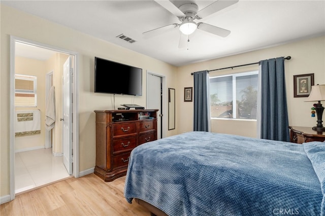 bedroom featuring light wood finished floors, visible vents, baseboards, and a ceiling fan