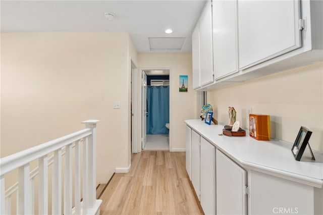 hall with an upstairs landing, recessed lighting, light wood finished floors, baseboards, and attic access