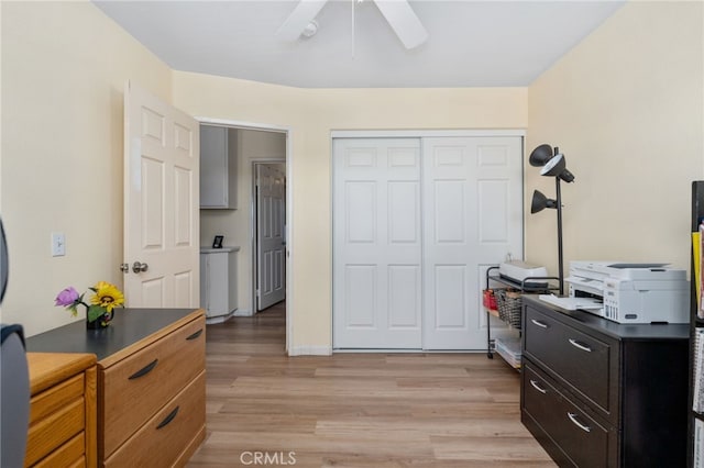 bedroom with a closet, a ceiling fan, and light wood finished floors