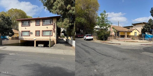 view of front facade featuring stucco siding and fence