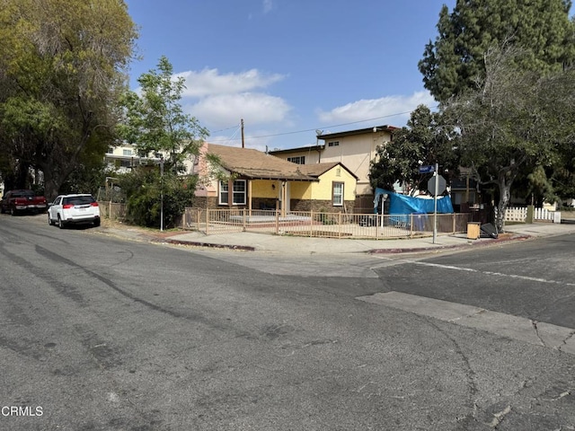 view of front of home featuring fence and stucco siding