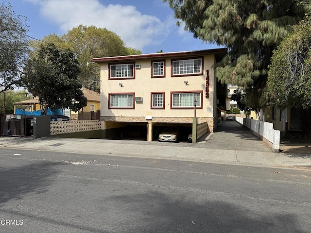 view of front of home featuring fence and stucco siding