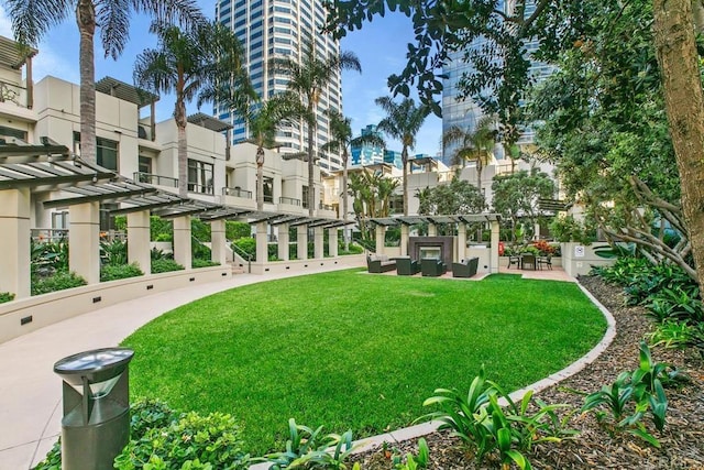 view of home's community with a yard and a pergola