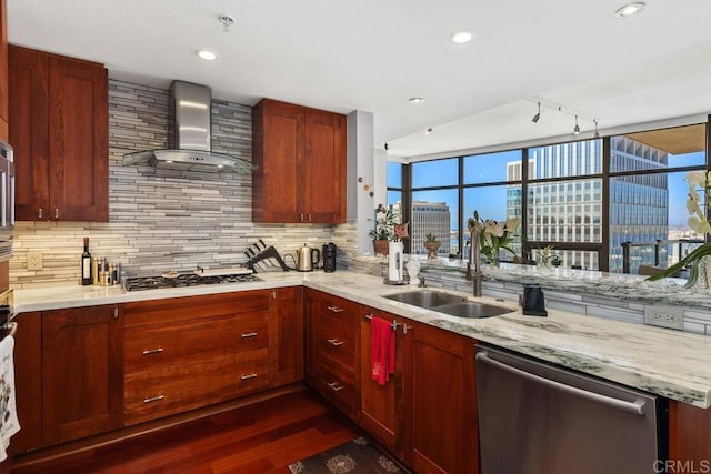 kitchen featuring light stone counters, dark wood-type flooring, appliances with stainless steel finishes, wall chimney range hood, and tasteful backsplash