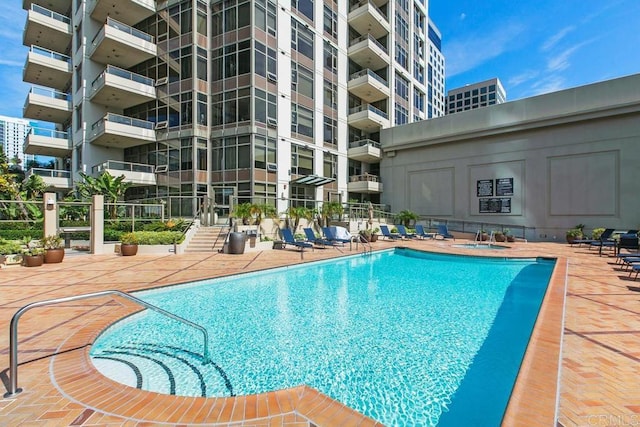 community pool featuring a patio area and fence