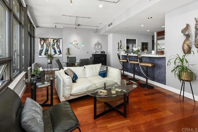 living area featuring track lighting, recessed lighting, baseboards, and wood finished floors