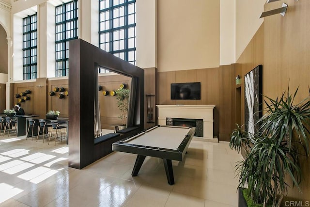 view of patio featuring a warm lit fireplace