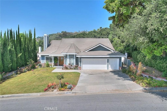 single story home with a front yard, an attached garage, a chimney, concrete driveway, and a tiled roof