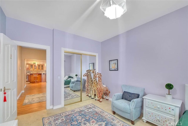 sitting room featuring baseboards and light colored carpet