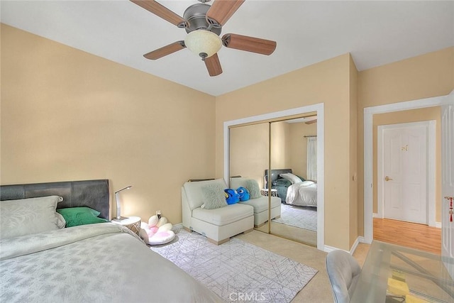 bedroom with baseboards, a closet, and ceiling fan