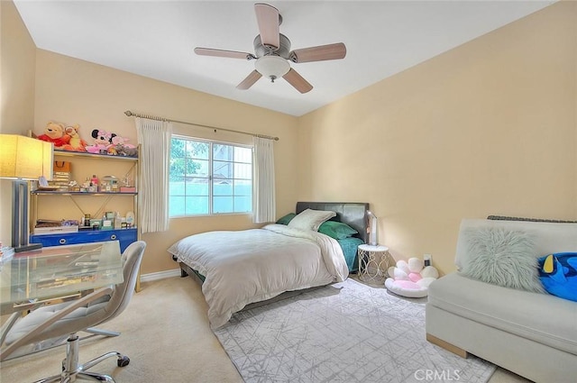 bedroom featuring baseboards, carpet floors, and a ceiling fan