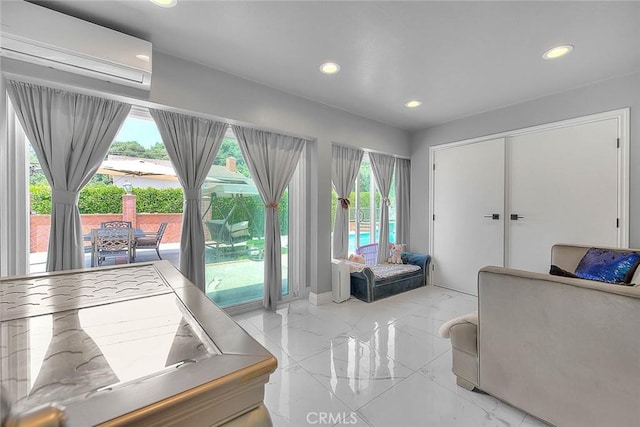 living area with recessed lighting, a wall mounted air conditioner, and marble finish floor