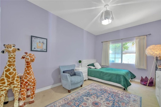 carpeted bedroom featuring baseboards and lofted ceiling