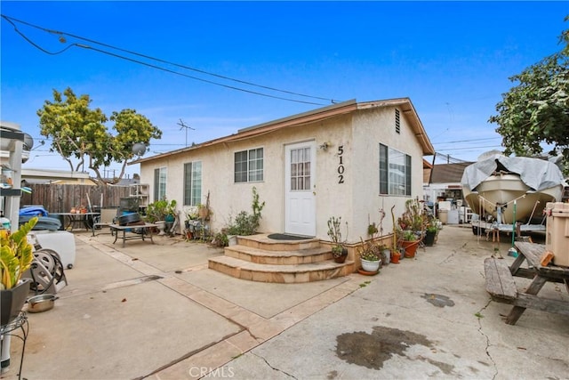 back of property featuring a patio area, stucco siding, and fence