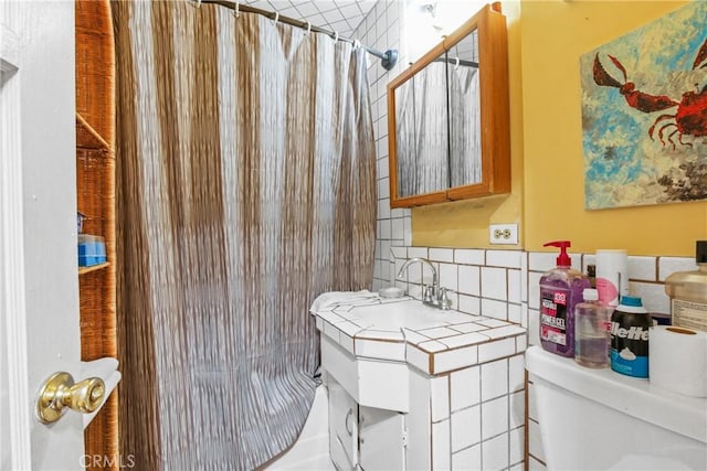 bathroom featuring backsplash, curtained shower, toilet, and vanity