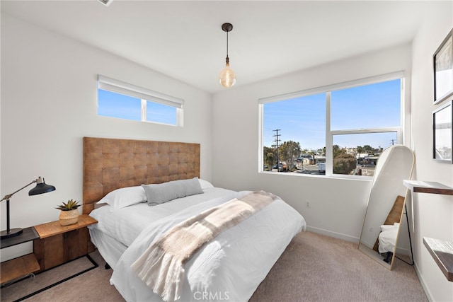 bedroom featuring multiple windows, baseboards, and carpet floors