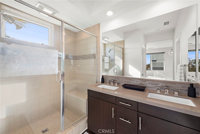 full bath featuring visible vents, a shower stall, a healthy amount of sunlight, and a sink