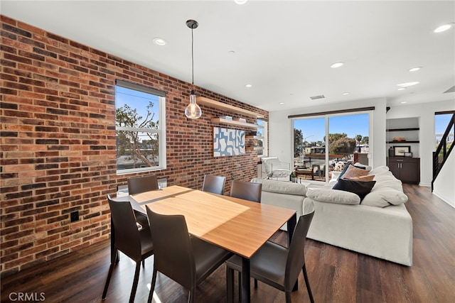 dining space with recessed lighting, visible vents, wood finished floors, and brick wall