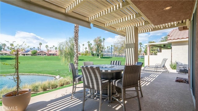 view of patio featuring a pergola, outdoor dining area, and a water view