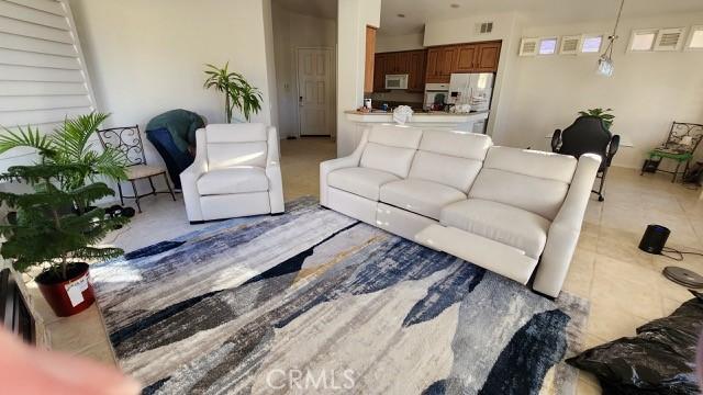 tiled living area featuring visible vents