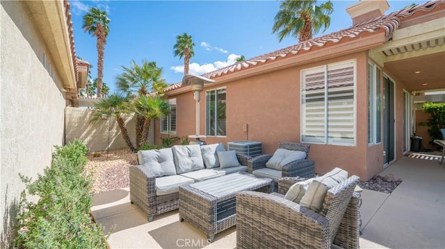 view of patio / terrace with an outdoor living space and fence