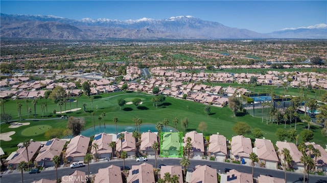 bird's eye view with view of golf course, a mountain view, and a residential view