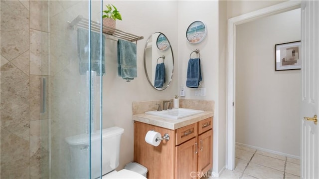 full bathroom with tile patterned floors, toilet, vanity, and a tile shower