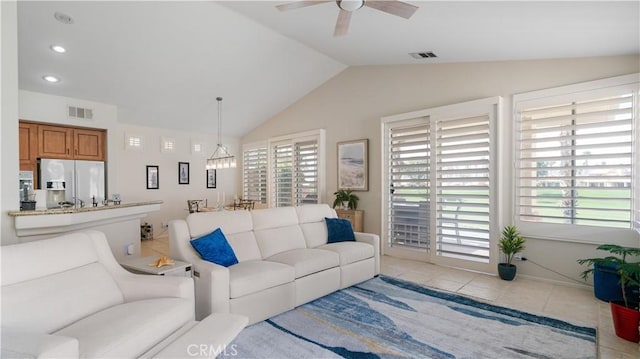 living area featuring ceiling fan, visible vents, lofted ceiling, and light tile patterned flooring