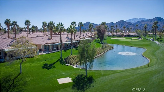 surrounding community featuring a lawn, golf course view, and a water and mountain view