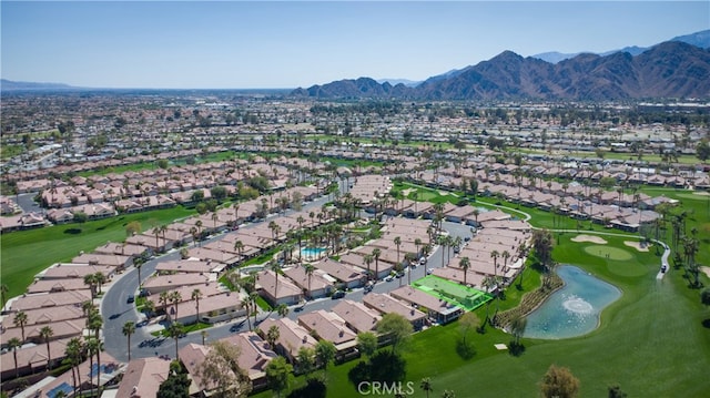 aerial view featuring a residential view, golf course view, and a water and mountain view
