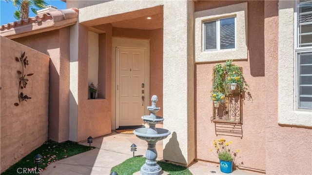 entrance to property with stucco siding