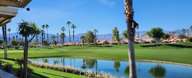 view of community featuring a lawn and a water view